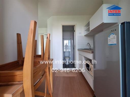 Spacious kitchen with wooden dining set and modern appliances