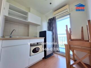 Compact and well-equipped kitchen with balcony access