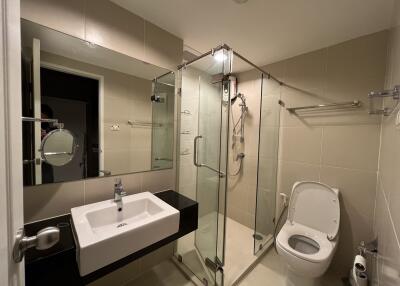 Modern bathroom with glass shower enclosure and minimalist design