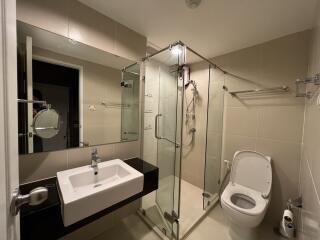 Modern bathroom with glass shower enclosure and minimalist design