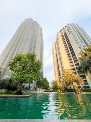High-rise residential buildings with a swimming pool in the foreground