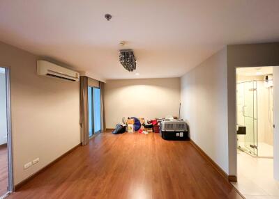 Spacious living room with wooden flooring and modern air conditioning