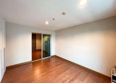 Spacious and brightly lit empty living room with hardwood floors