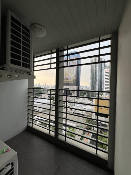 Urban view from a high-rise apartment balcony with cityscape