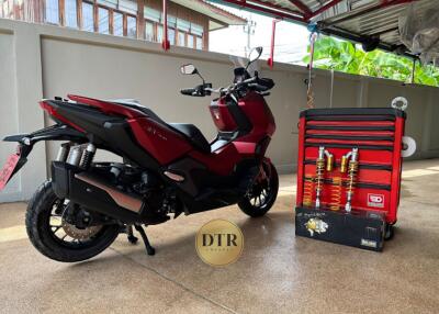 Modern garage space with red electric scooter and tool cabinet