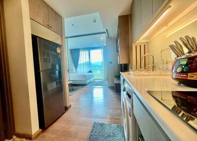 Modern kitchen with seamless connection to a living area featuring ample natural light