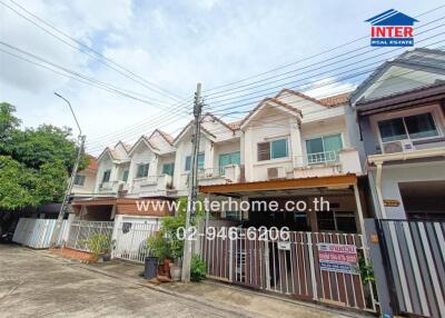 Two-story row houses with front yards and driveways