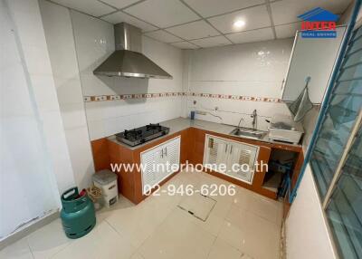 Modern kitchen with stove, sink, and exhaust hood