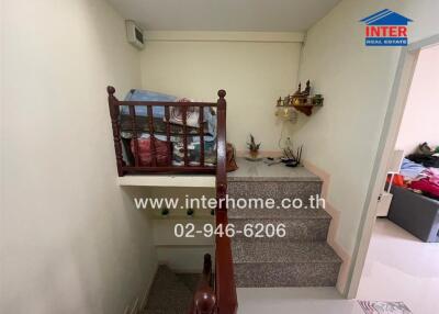 Interior view of a staircase in a home with storage items