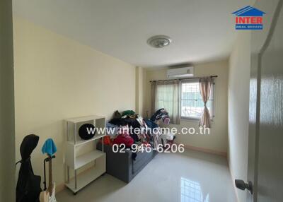 Bright and spacious bedroom with large window and ample storage space