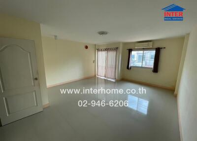 Living room with tiled floor, window with blinds, and air-conditioner