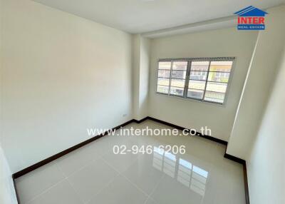Bright and spacious empty bedroom with large windows and glossy tiled flooring