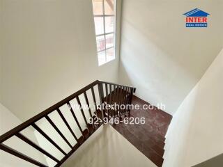 Elegant wooden staircase in a well-lit home interior