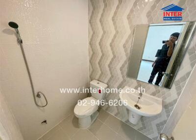 Modern bathroom with walk-in shower, ceramic basin, and decorative tiles