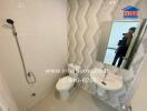 Modern bathroom with walk-in shower, ceramic basin, and decorative tiles