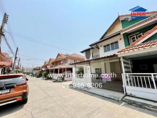 Suburban street view featuring a row of residential houses