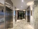 Elegant building lobby with marble floors and modern elevators