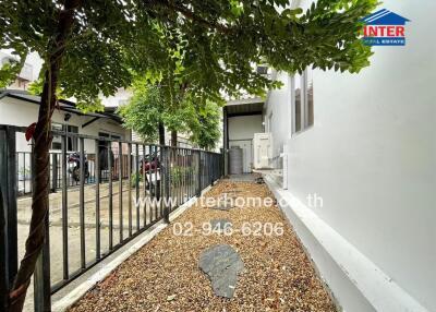 Well-maintained outdoor area of a residential property with gravel path and fencing