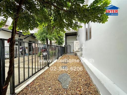 Well-maintained outdoor area of a residential property with gravel path and fencing