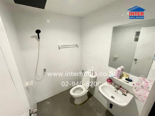 Modern white bathroom with wall-mounted fixtures and subtle lighting