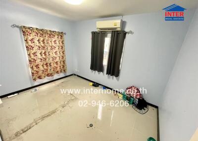 Empty bedroom interior with air conditioning and patterned curtains