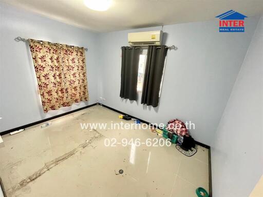 Empty bedroom interior with air conditioning and patterned curtains