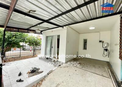 Spacious patio with partial roofing and sliding door entrance
