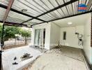 Spacious patio with partial roofing and sliding door entrance