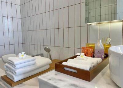 Modern bathroom with neatly organized towels and toiletries