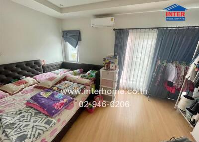 Spacious bedroom with large bed and plenty of natural light