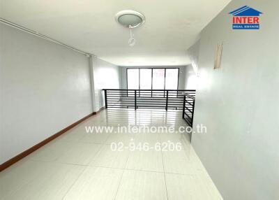 Spacious and brightly lit empty living room with tiled floors