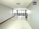 Spacious and brightly lit empty living room with tiled floors