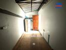 Spacious hallway with natural lighting and wooden door