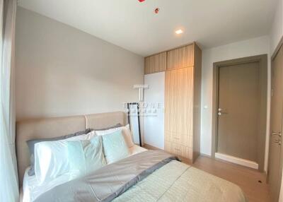 Modern bedroom with beige color scheme and natural light