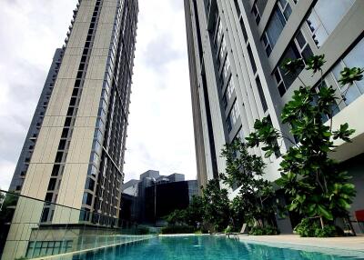 Modern high-rise residential buildings beside a swimming pool
