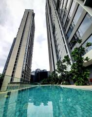 Modern high-rise residential buildings beside a swimming pool