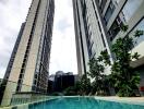 Modern high-rise residential buildings beside a swimming pool