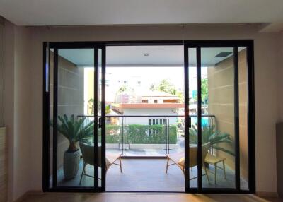Modern balcony with sliding glass doors overlooking an urban area
