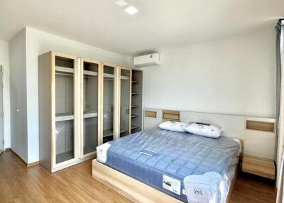 Spacious and bright bedroom with large bed and built-in wardrobes