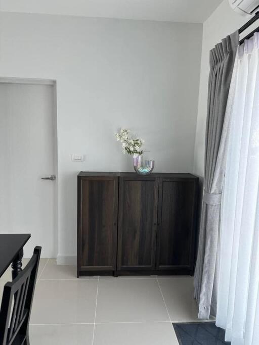 Minimalist bedroom with wooden cabinet and floral decoration