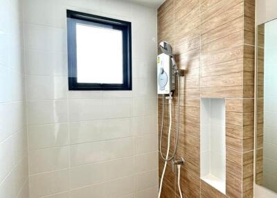 Modern and clean bathroom with wooden accents and a handheld shower