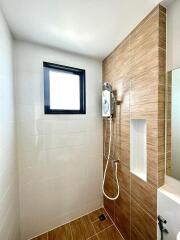 Modern and clean bathroom with wooden accents and a handheld shower