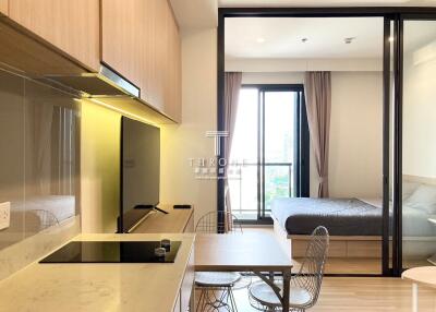 Modern studio apartment interior with combined living, dining, and sleeping area