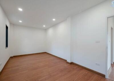 Spacious and minimalistic bedroom with hardwood flooring