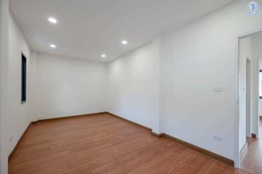 Spacious and minimalistic bedroom with hardwood flooring