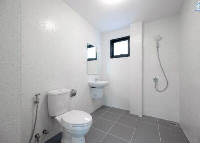Modern white bathroom with toilet and shower