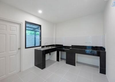 Modern kitchen with sleek black countertops and white cabinetry