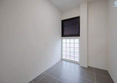 Bright empty room with large window and gray tiles
