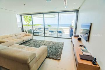 Modern living room with ocean view and access to outdoor terrace