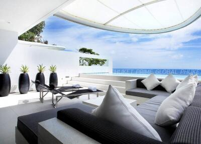 Modern outdoor lounge area with ocean view and plush seating